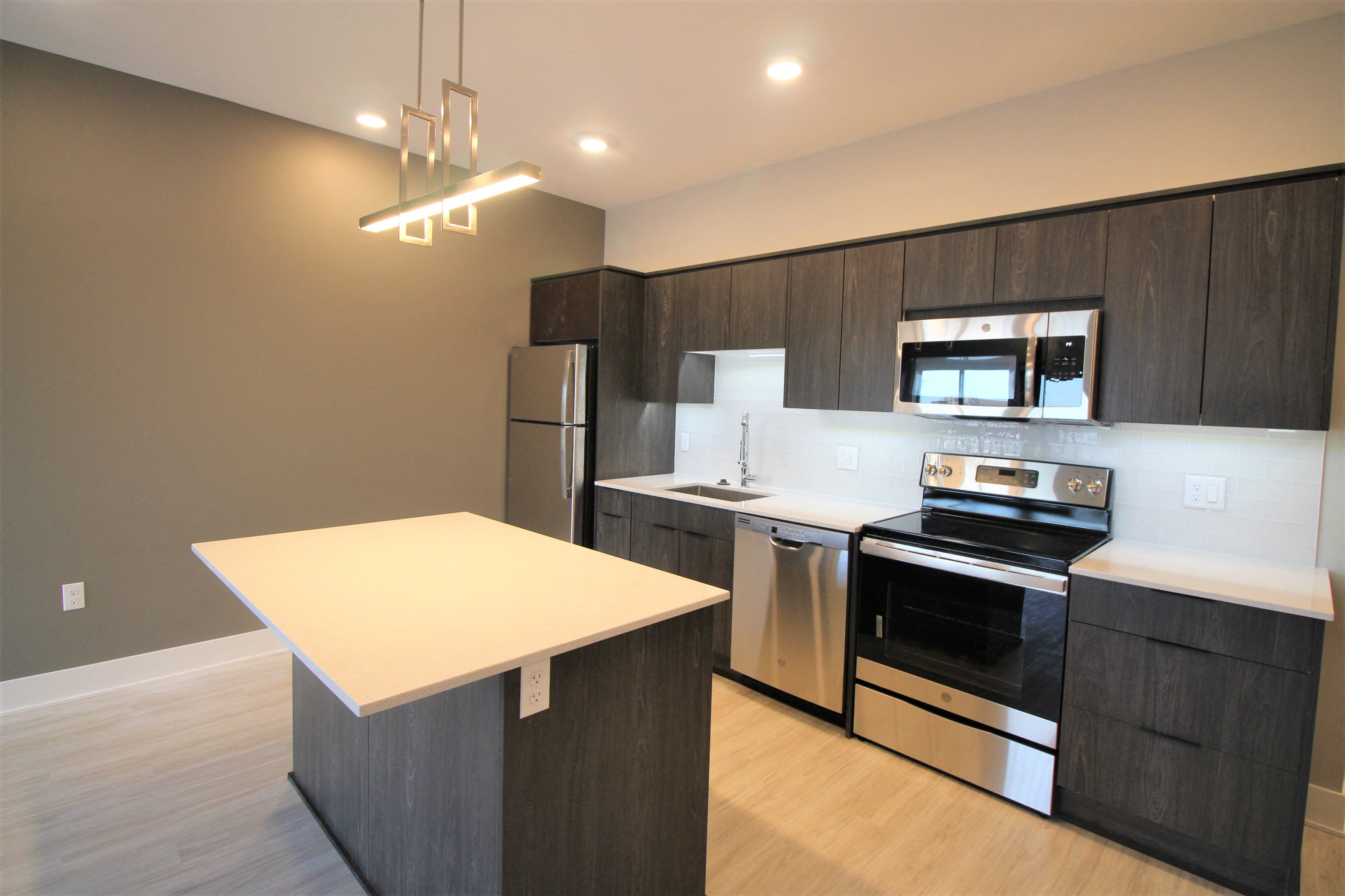 a kitchen with stainless steel appliances and a white counter top