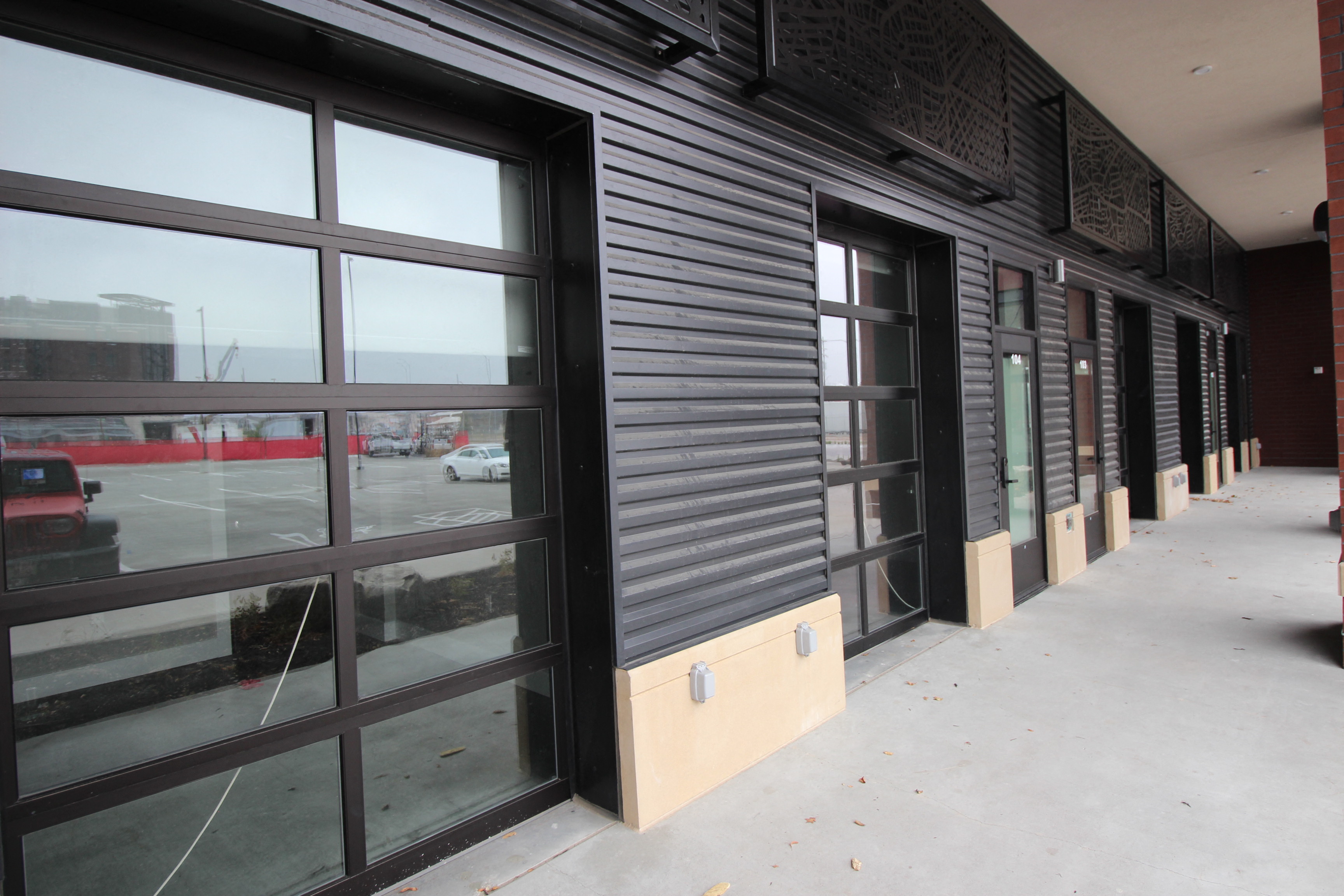 a view of the outside of a building with glass doors and windows