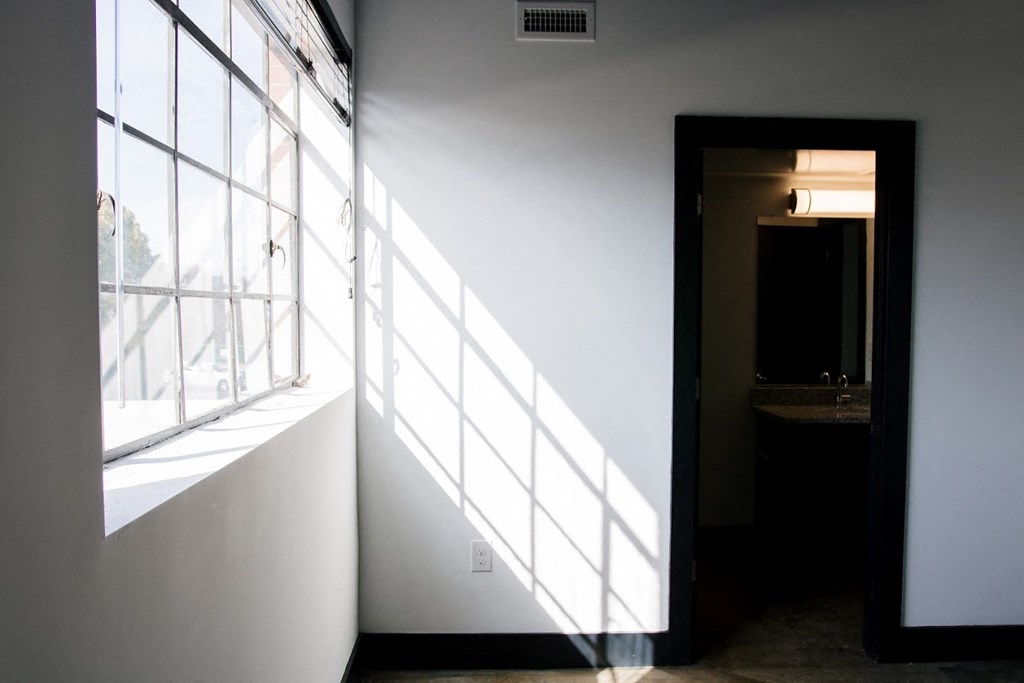 a room with a large window and a door