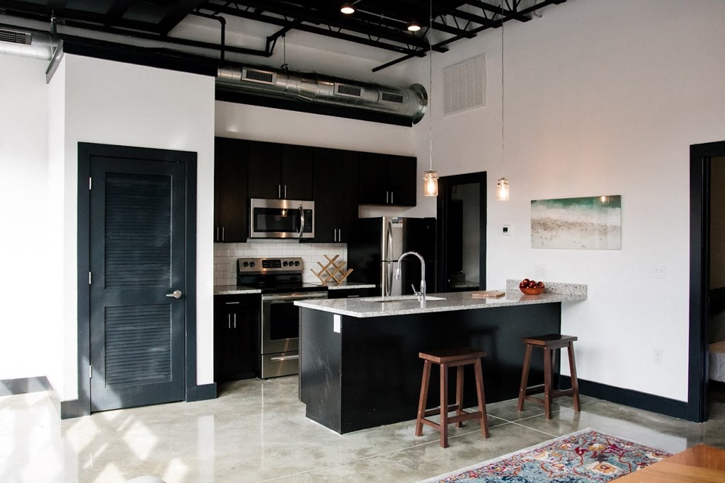 a kitchen with black cabinets and a counter top