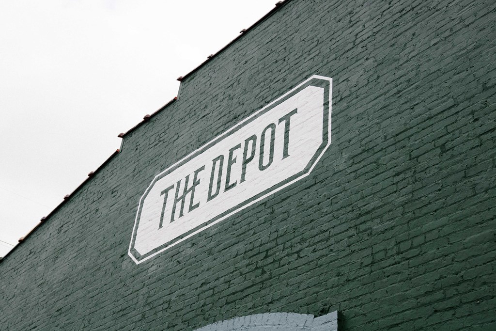 an old brick building with a sign that reads the depot