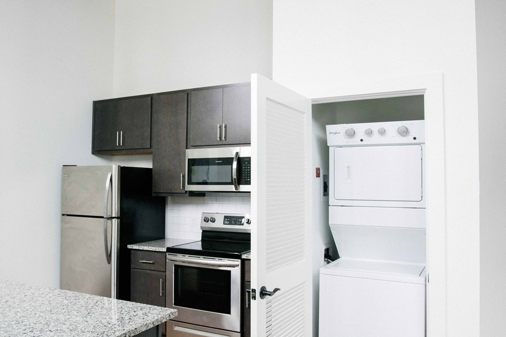 a kitchen with white appliances and black and white cabinets
