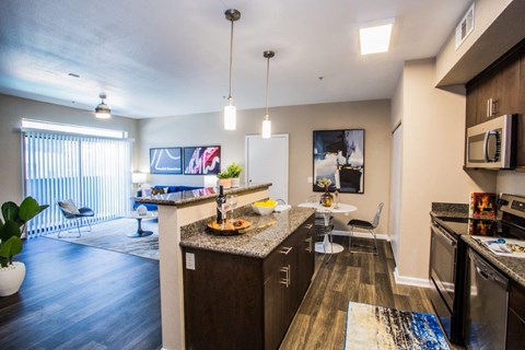 A kitchen with a dining table and chairs.