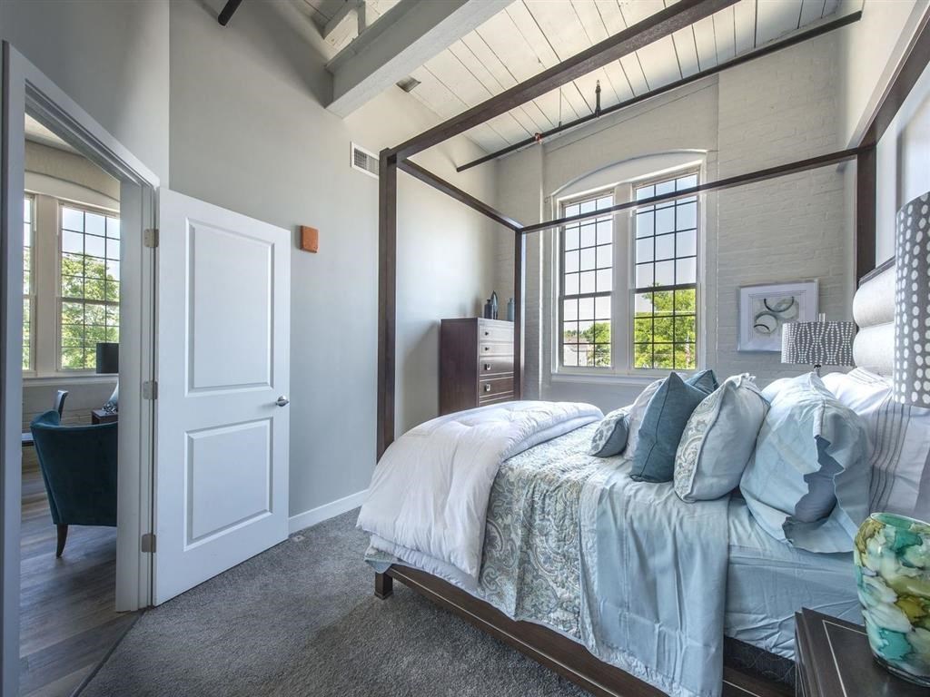 a bedroom with a bed and a door to a bathroom