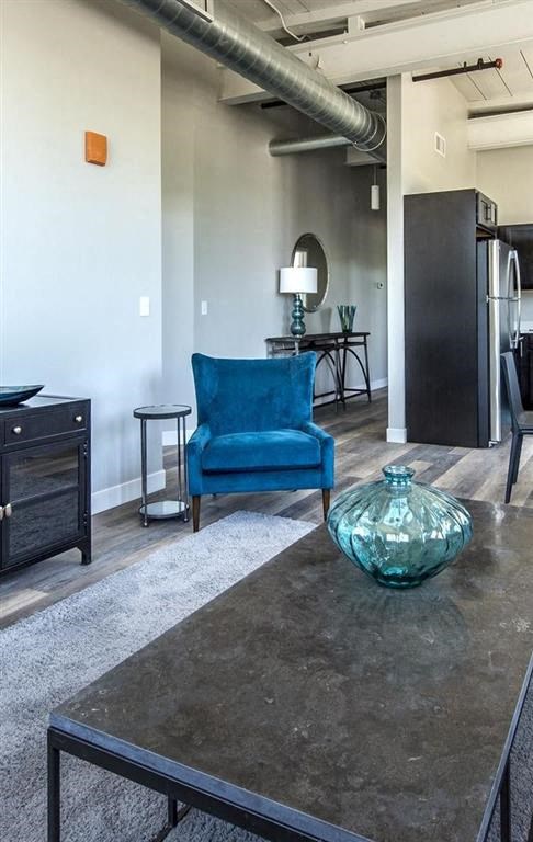 a living room with a blue chair and a table