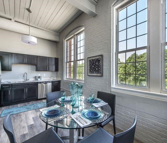 a dining room with a glass table and chairs