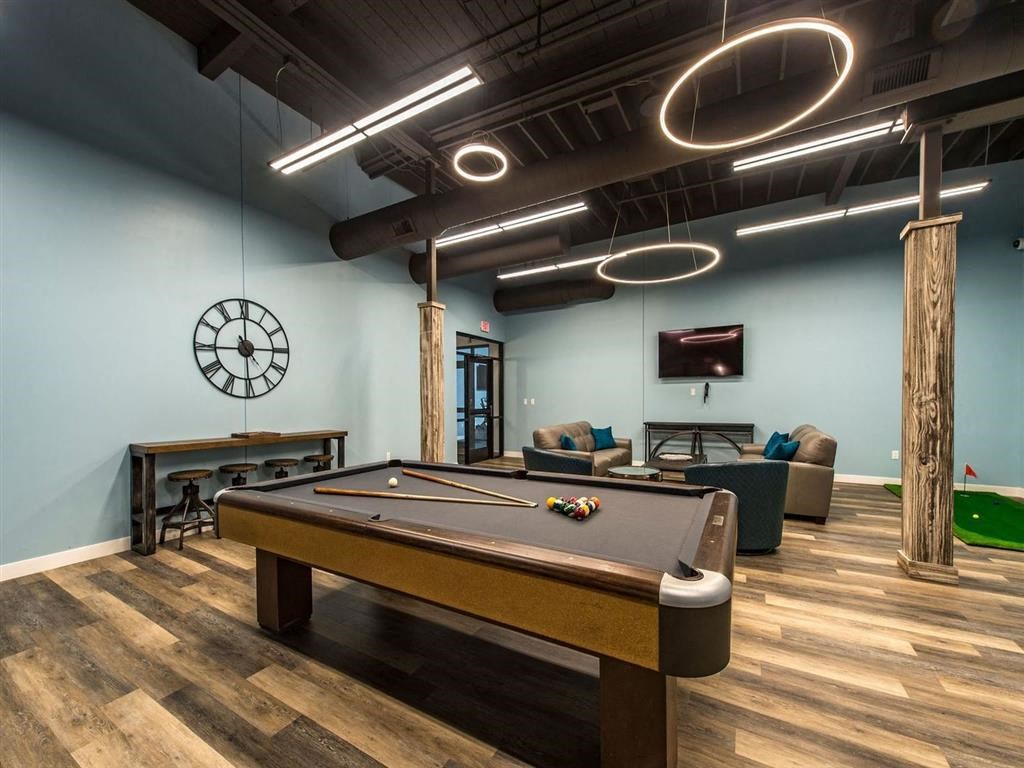 a game room with a pool table and a tv