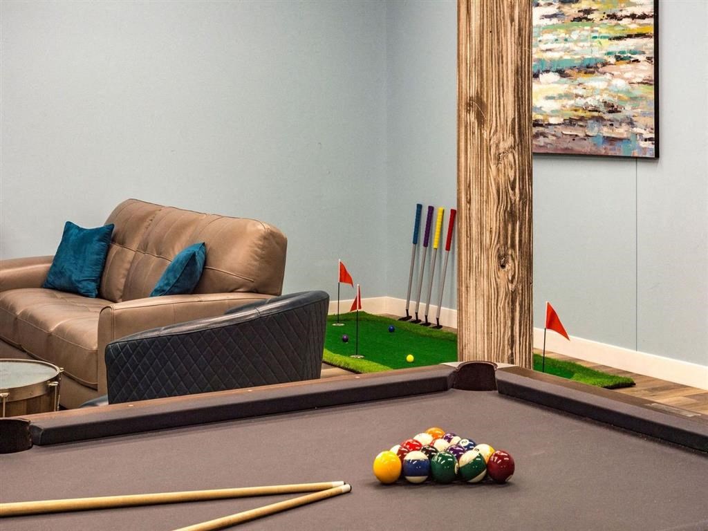a living room with a pool table and
