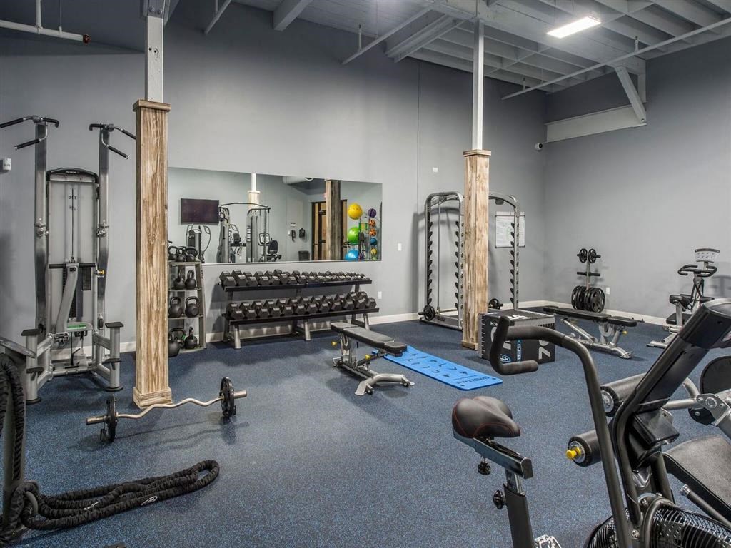 a gym with weights and other exercise equipment in a building