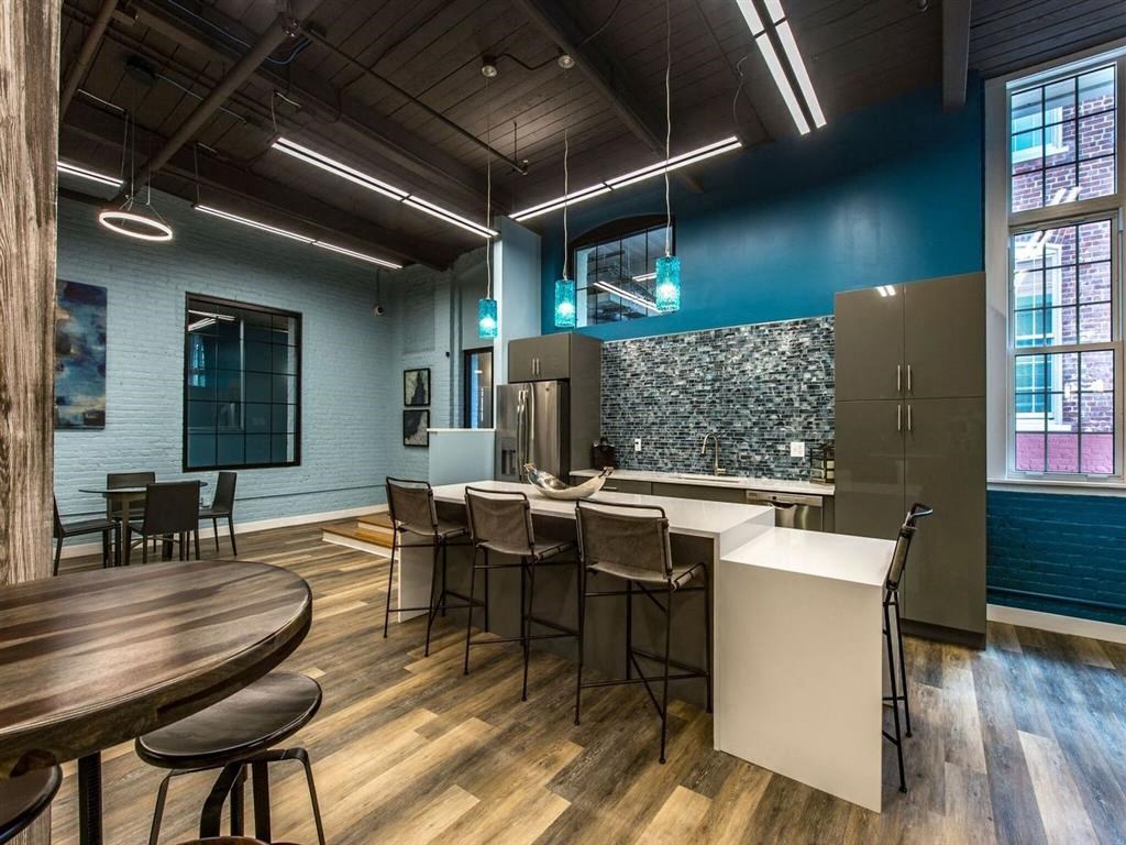 a kitchen and dining area in a room with a table and chairs