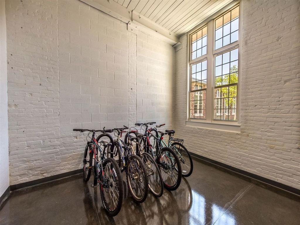 a group of bikes parked in a room next to a window