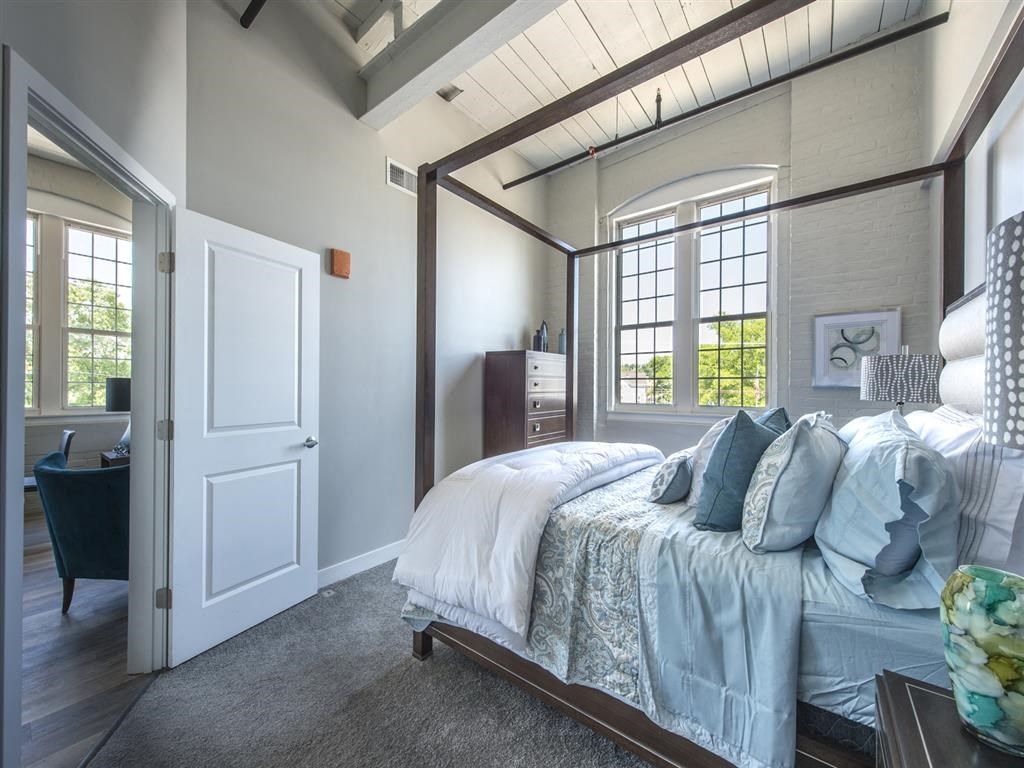 a bedroom with a bed and a door to a bathroom