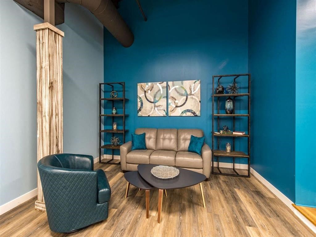 a living room with blue walls and a couch and a table