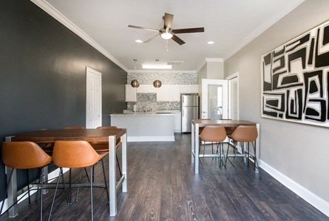 A modern kitchen with a dining table and chairs.