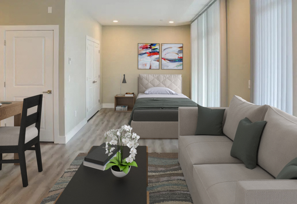 a living room with a couch and a table and a bed