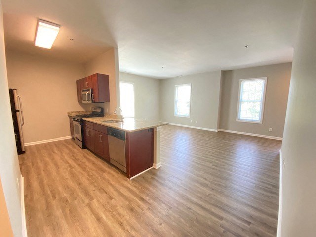 Wide view of kitchen and living room.
