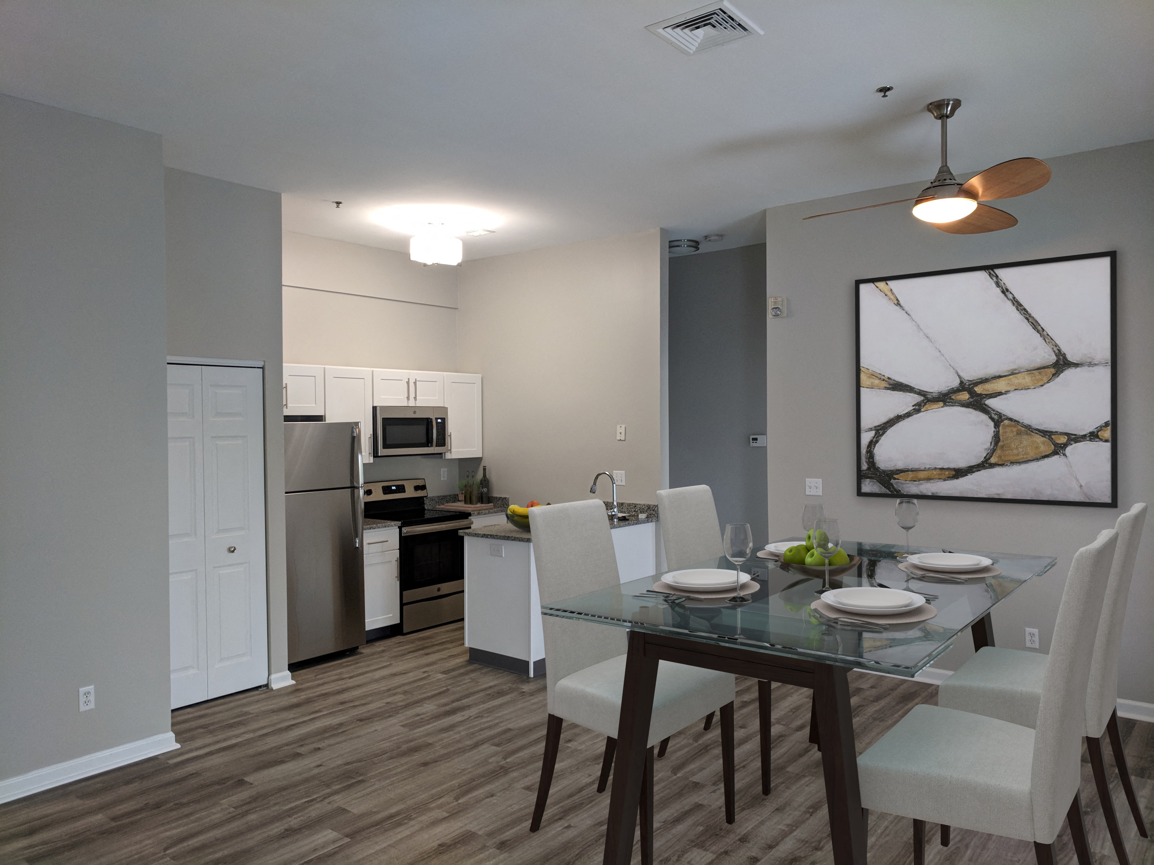 an open kitchen and dining room with a glass table and chairs