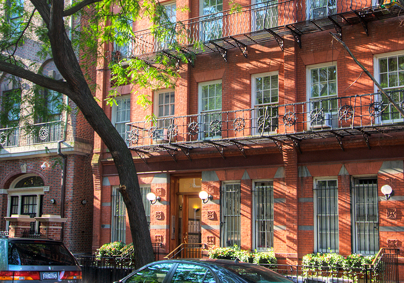 a red brick building with cars parked in front of it