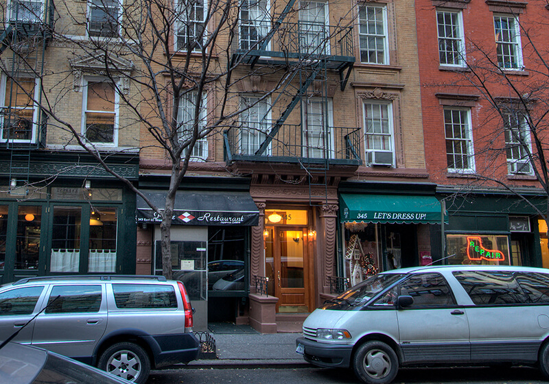 a city street with cars parked in front of buildings