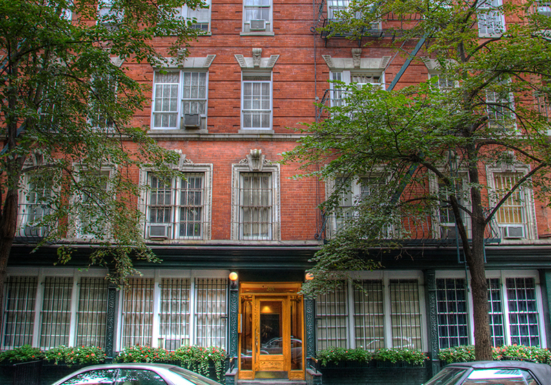 a building with two cars parked in front of it