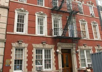 a red brick building with windows and a fire escape