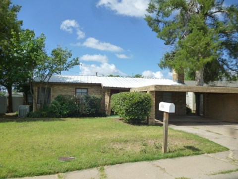 a small brick house with a mailbox in front of it