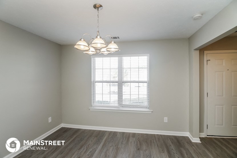 the living room of a new home with a window and a door