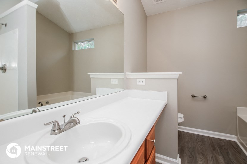 a bathroom with a sink and a mirror and a toilet