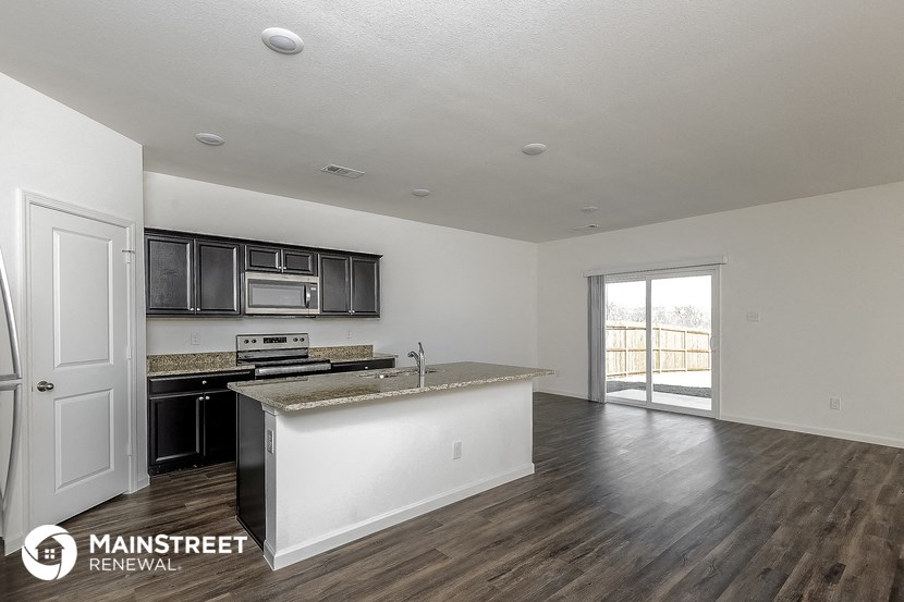 the kitchen and living room of an apartment