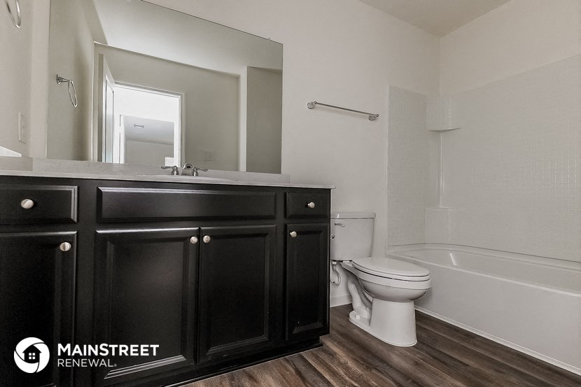 a bathroom with a toilet and a sink and a mirror