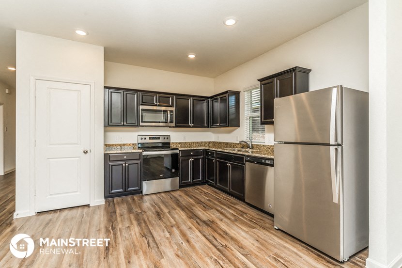 the kitchen is updated with stainless steel appliances and black cabinets