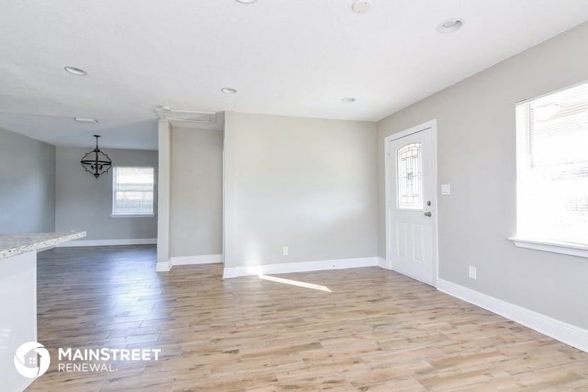 the living room and dining room with hardwood flooring