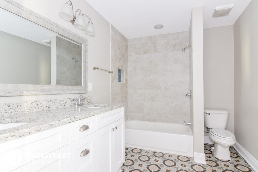 a bathroom with a toilet and a sink and a shower