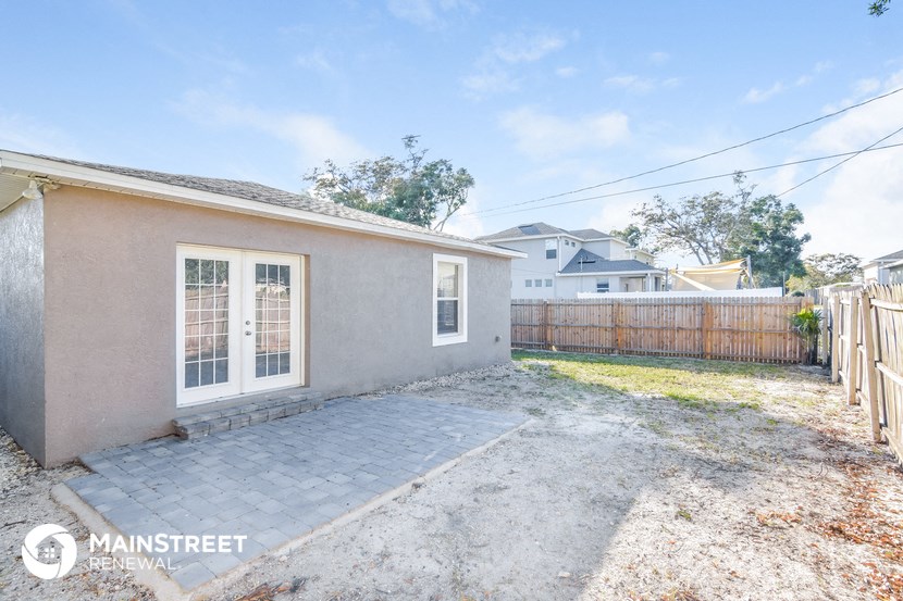 a small house with a backyard and a fence