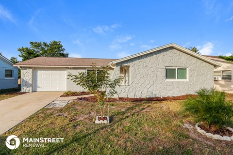 a white house with a driveway and a garage door