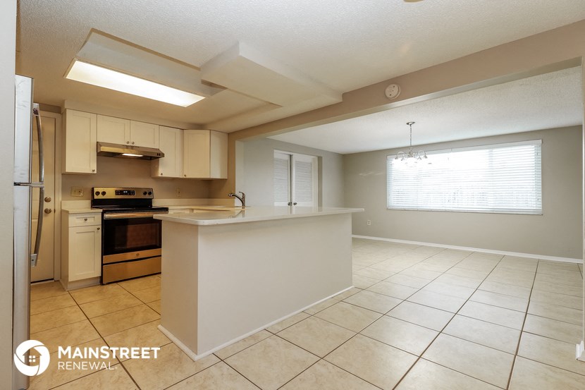 a kitchen with an island and a stove and a window