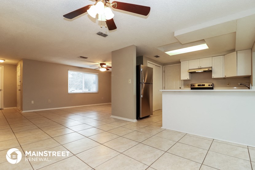 the kitchen and living room are spacious with tile flooring and stainless steel appliances
