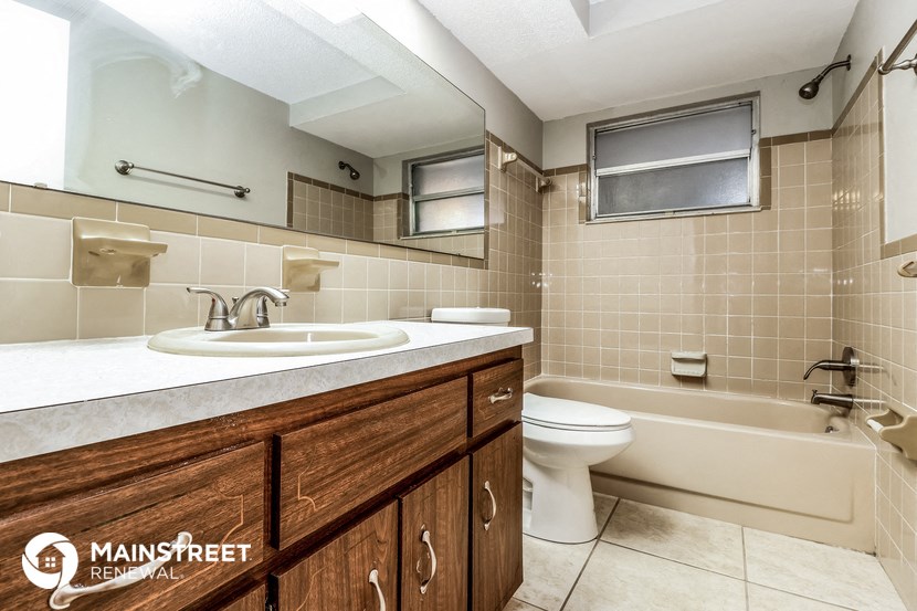 a bathroom with a sink and a toilet and a bath tub