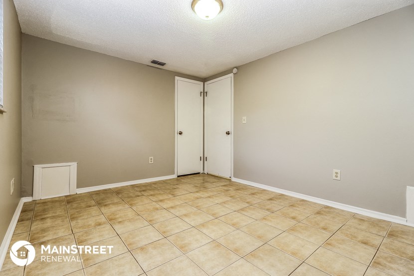 the living room of an empty house with a tile floor