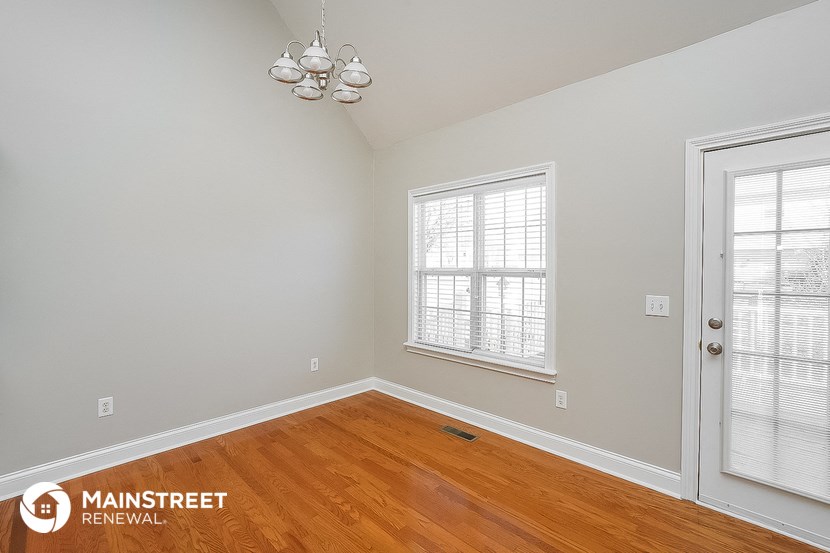 the master bedroom has a hardwood floor and two windows