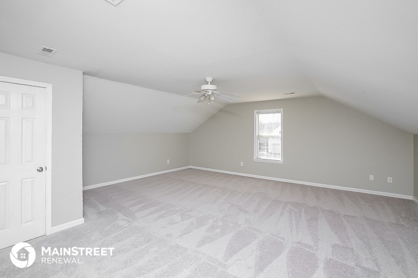 the living room of a home with a ceiling fan