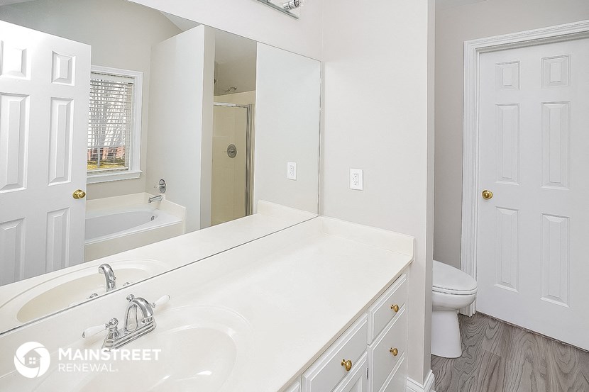 a bathroom with a sink and a toilet and a mirror