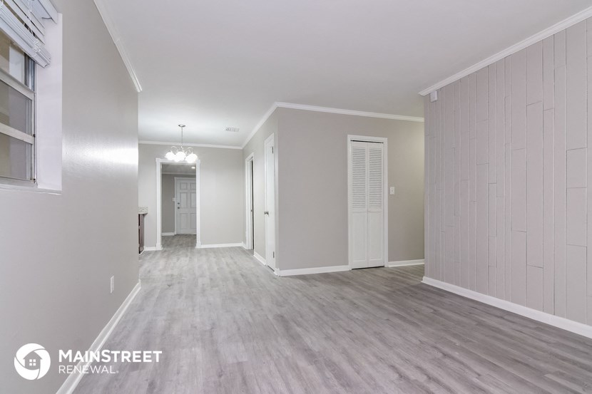 the living room and dining room of an apartment