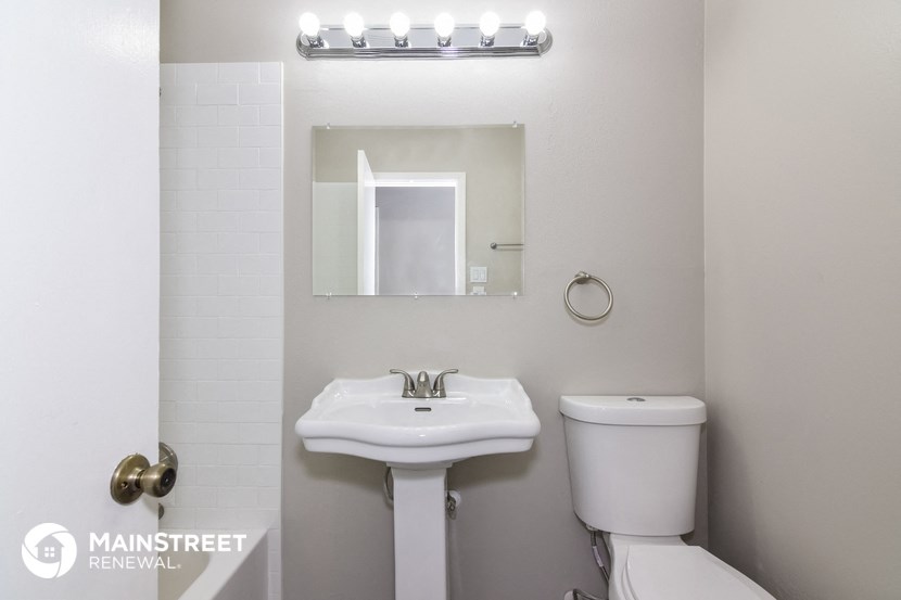 a bathroom with a sink and a mirror and a toilet