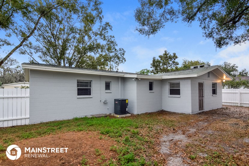 a white house with a yard and a white fence