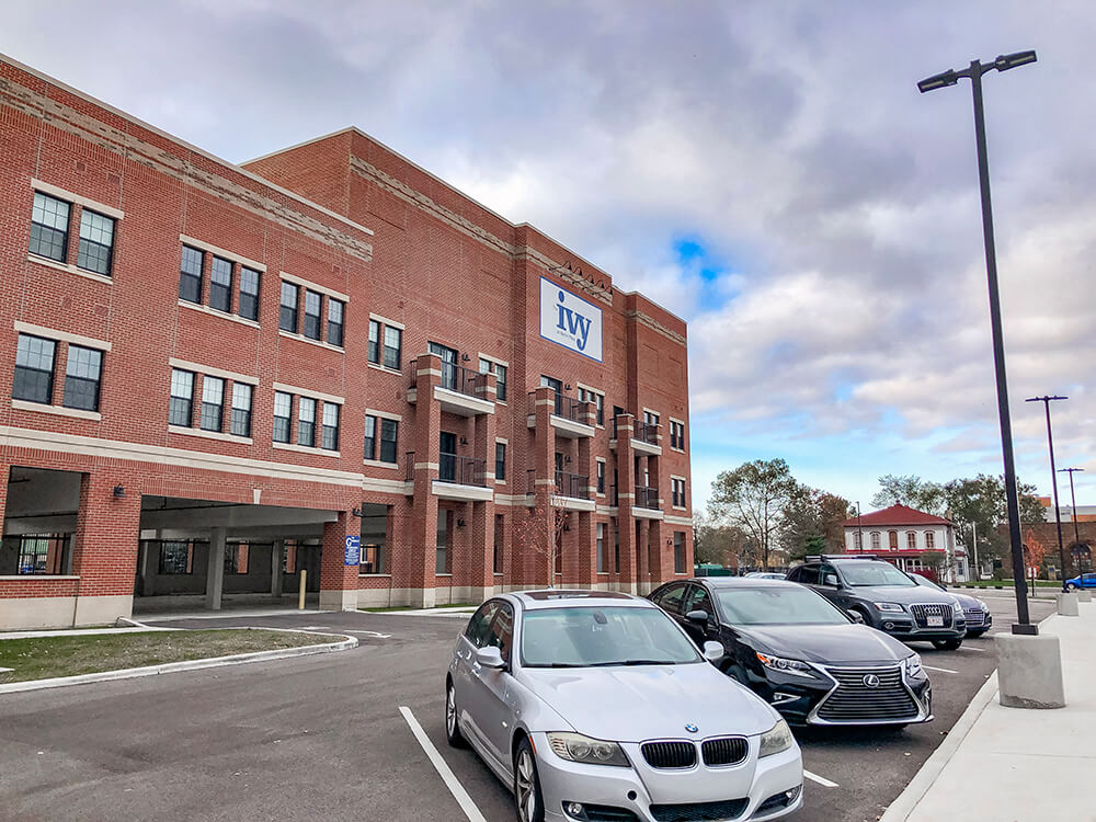 Surface parking with covered parking in the background at The Ivy at Berlin Place, Indiana