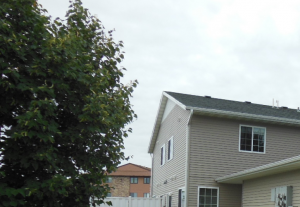 front view a house with a driveway and a lawn