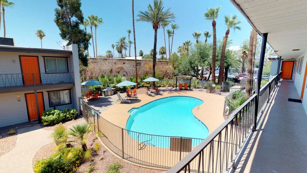 a swimming pool at a resort with palm trees