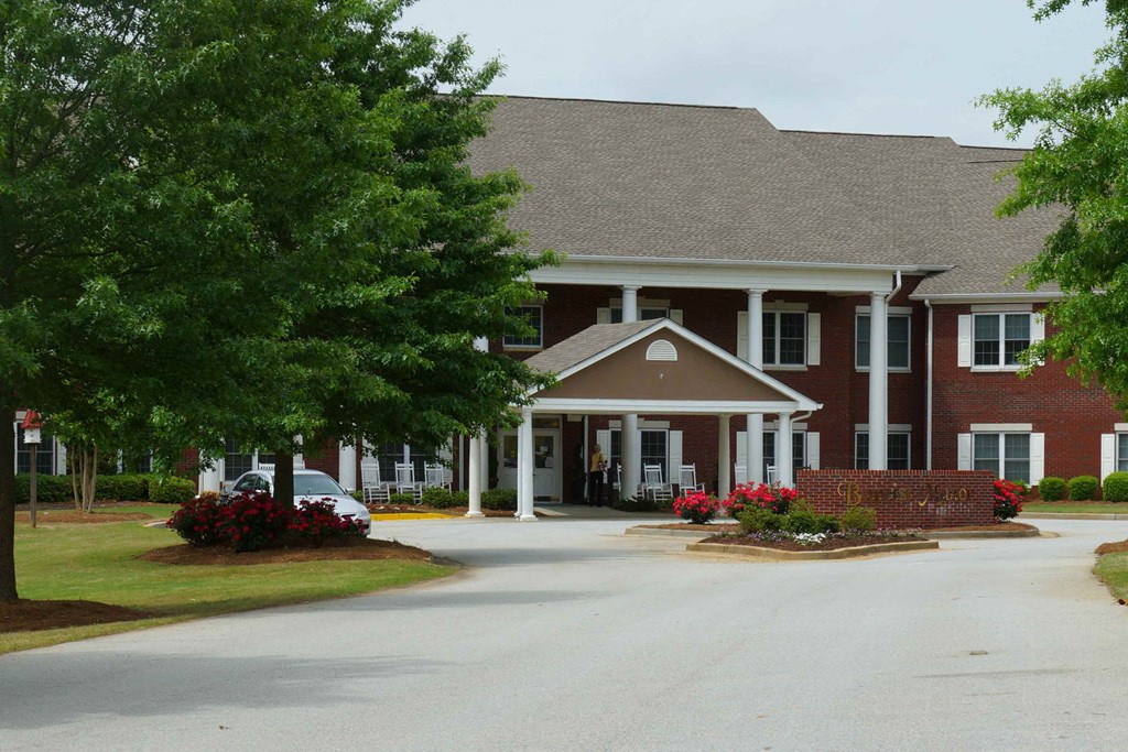 a large brick house with a car parked in front of it