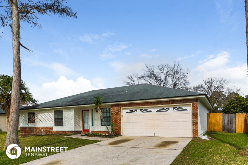 a small brick house with a white garage door